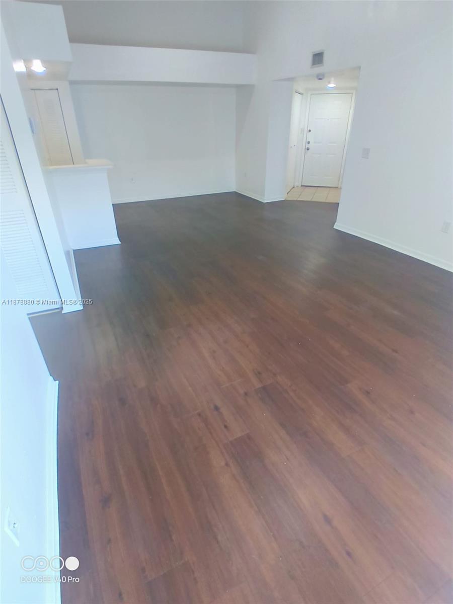 4183 Haverhill Road, Unit 712 West Palm Beach, FL 33417 - Photo 11 of 11 an empty room with wooden floor