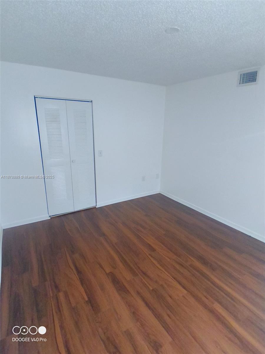 4183 Haverhill Road, Unit 712 West Palm Beach, FL 33417 - Photo 8 of 11 a view of empty room with wooden floor