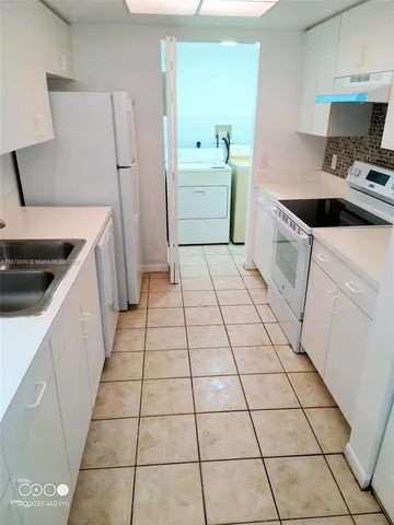 a kitchen with a sink and a stove top oven