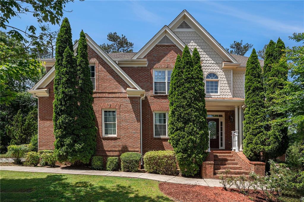 3329 Chastain Ridge Drive Marietta, GA 30066 - Photo 1 of 1 a front view of a house with garden