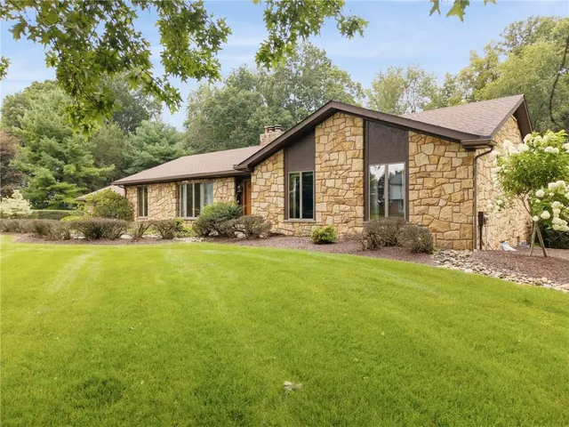 an aerial view of a houses with a yard