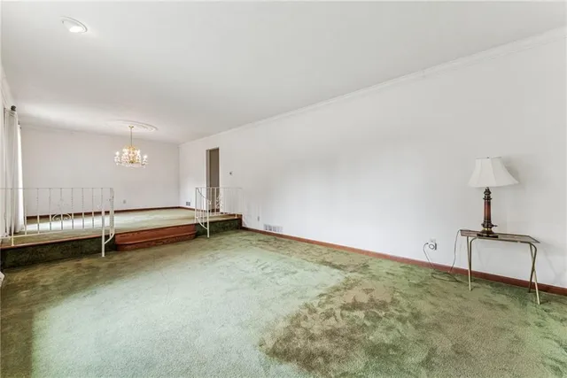 a view of a kitchen with a sink and a refrigerator