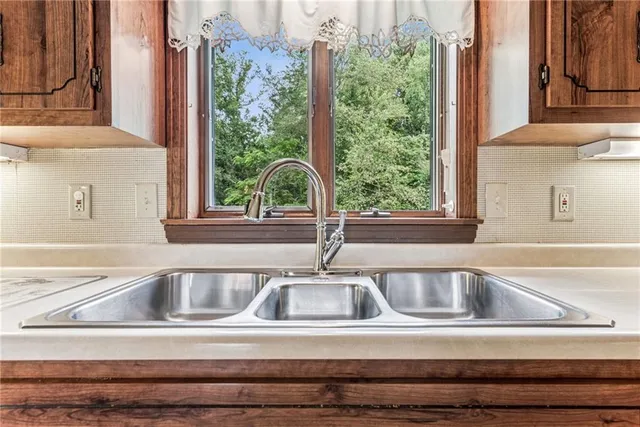 a kitchen with stainless steel appliances granite countertop a refrigerator sink and cabinets