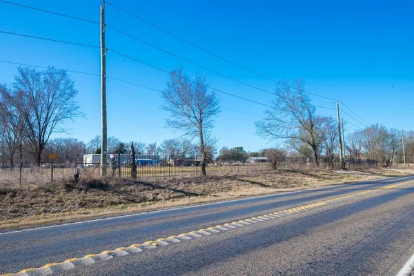 a view of a road with a wrought fence