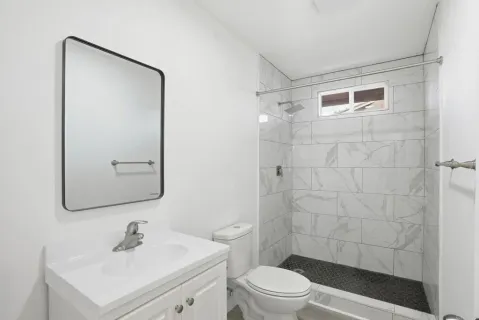 an empty room with wooden floor and window