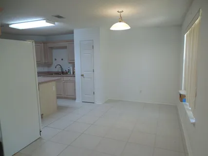a kitchen with white cabinets and white appliances