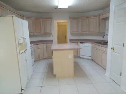a kitchen with white cabinets