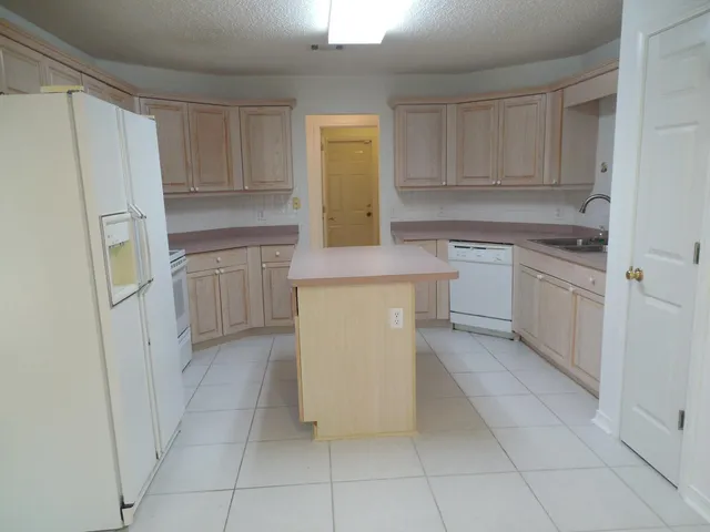 a kitchen with white cabinets