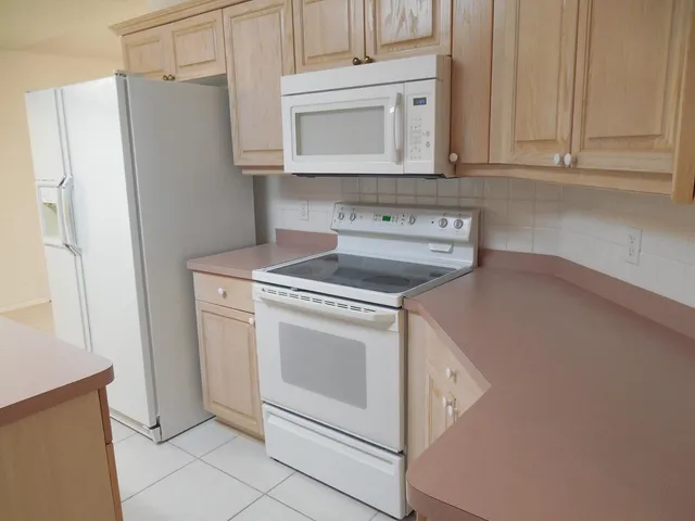 a kitchen with cabinets and stainless steel appliances