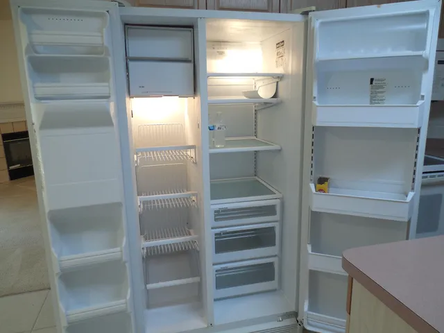 en empty room with windows and fan