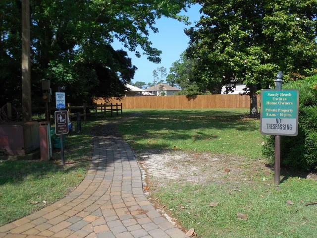 a view of a backyard with garden and patio