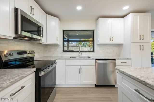 a kitchen with a sink stove and microwave