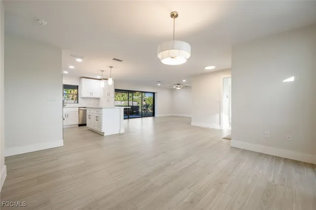 a view of a kitchen with a sink and dishwasher cabinets