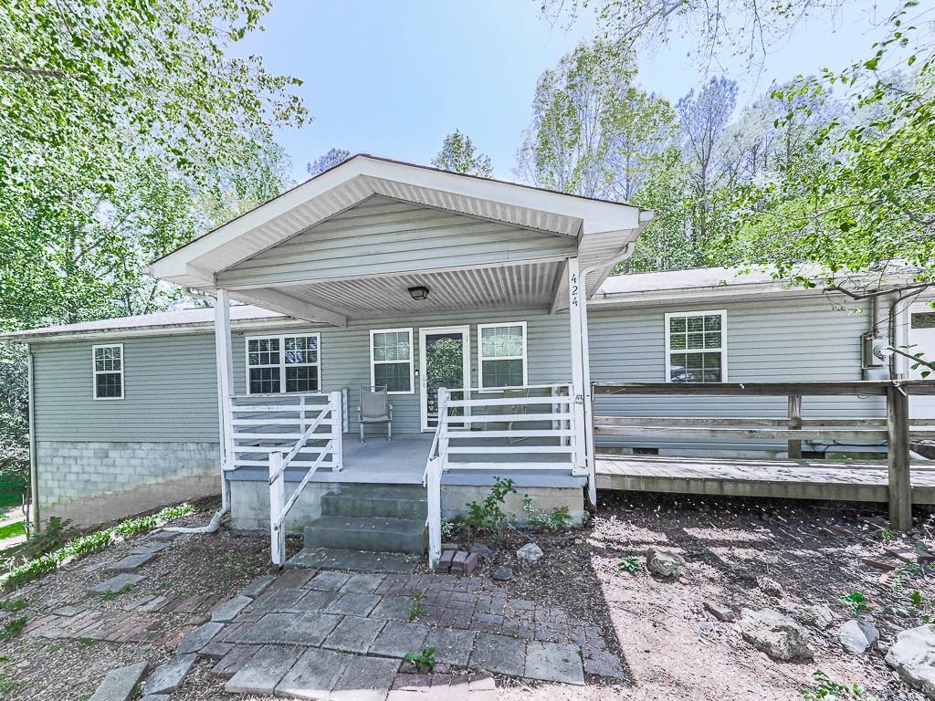 424 Shamrock Drive Dalton, GA 30721 - Photo 27 of 38 a view of a house with a yard chairs and wooden fence
