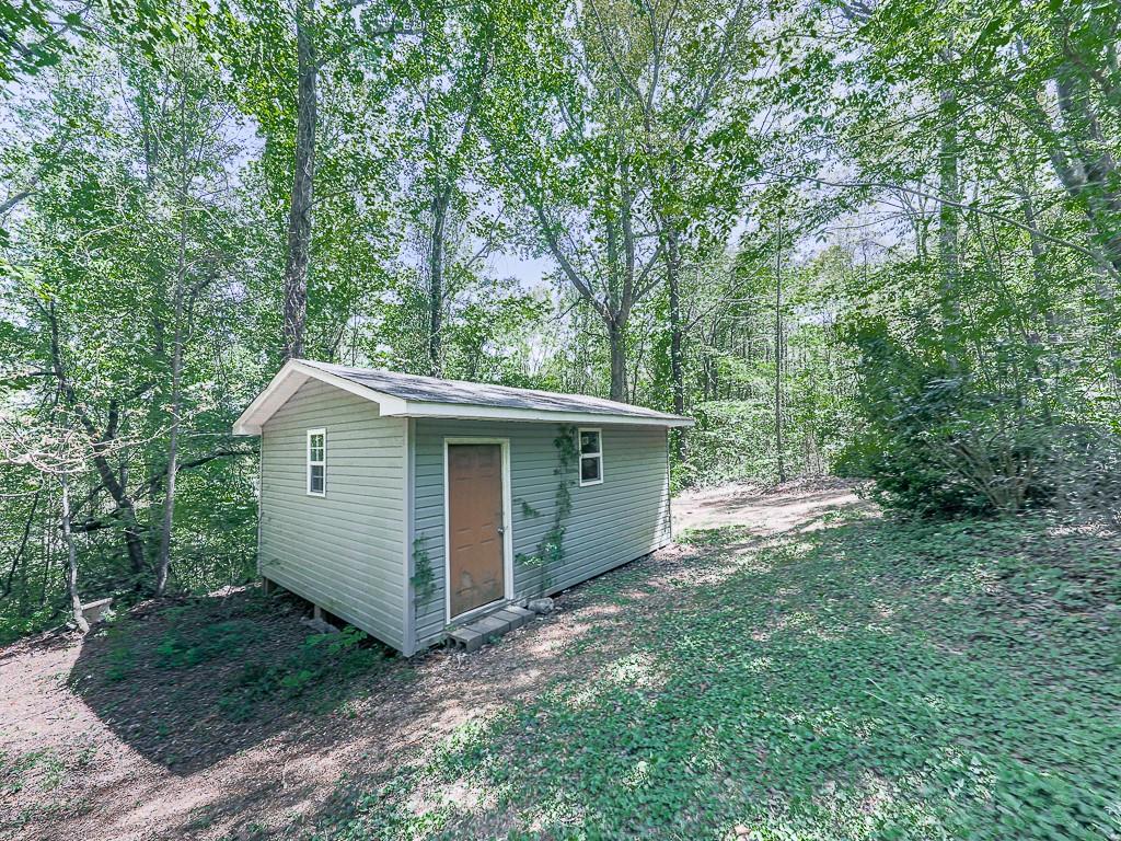 424 Shamrock Drive Dalton, GA 30721 - Photo 36 of 38 a view of a backyard with a barn and large trees