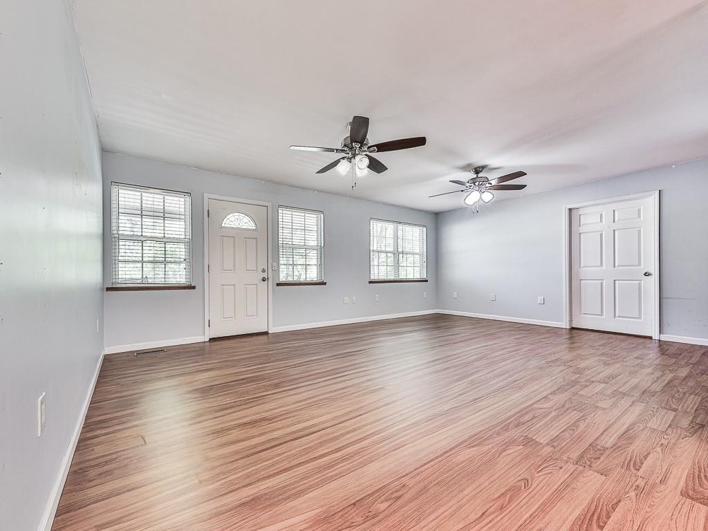 424 Shamrock Drive Dalton, GA 30721 - Photo 7 of 38 a view of an empty room with a window and wooden floor