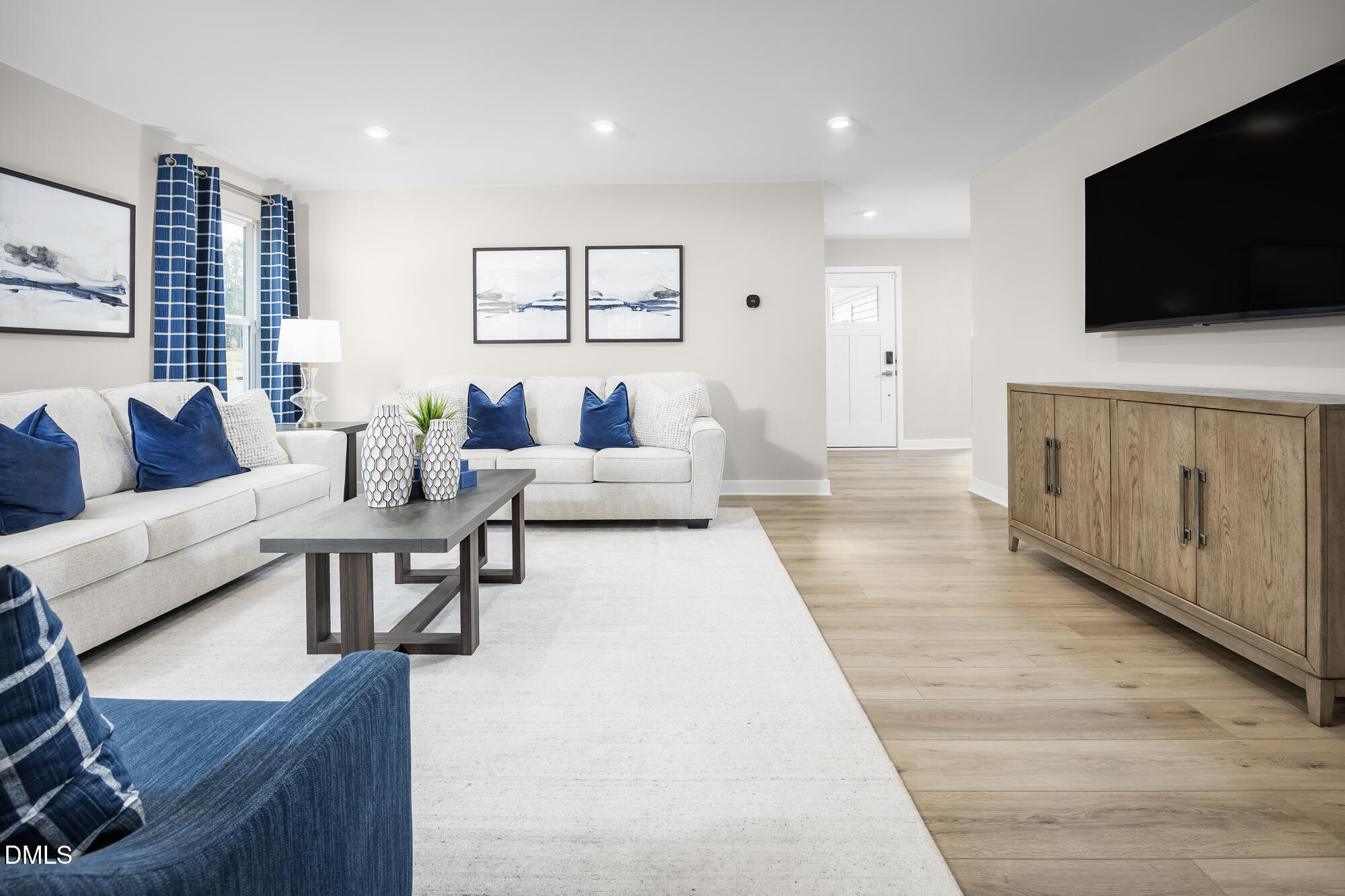 239 Country Side Way Fuquay-Varina, NC 27526 - Photo 7 of 15 a living room with furniture and a flat screen tv
