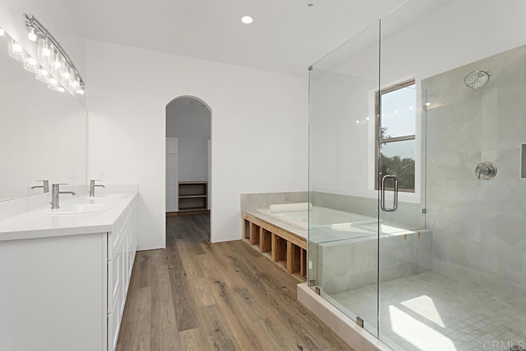 5808 Lake Vista Drive Bonsall, CA 92003 - Photo 18 of 40 a hallway with a sink and a mirror