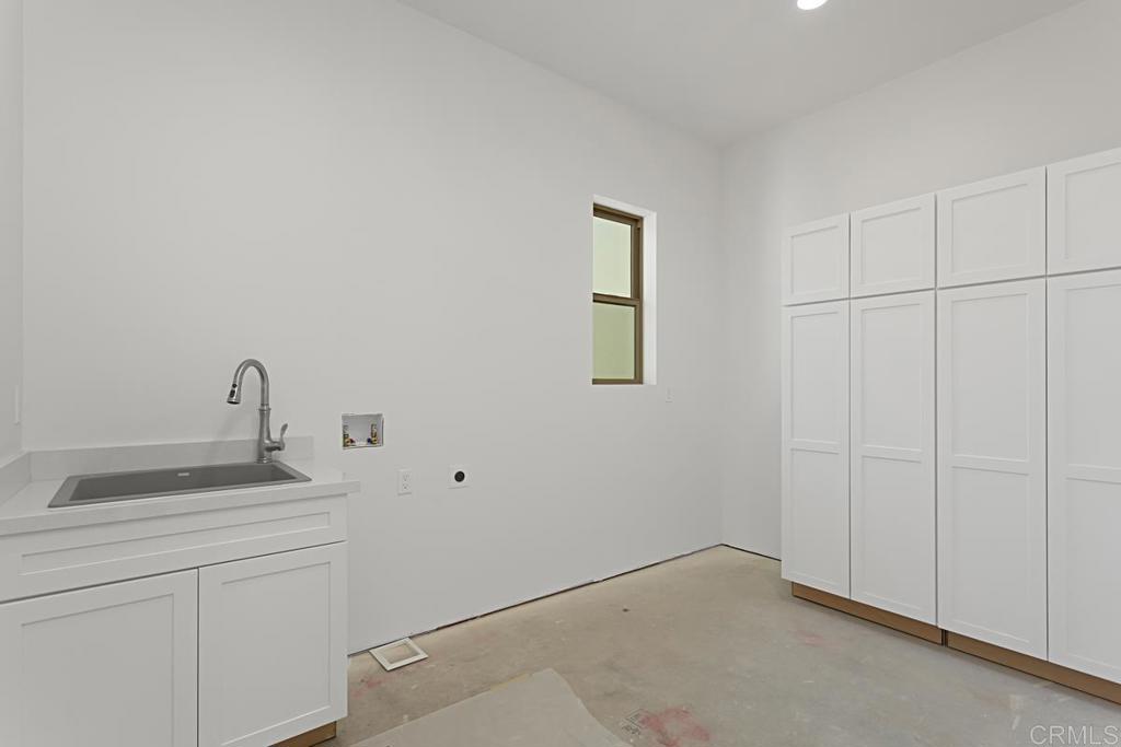5808 Lake Vista Drive Bonsall, CA 92003 - Photo 24 of 40 a room with a sink and cabinets
