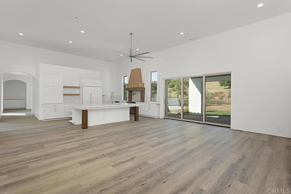 5808 Lake Vista Drive Bonsall, CA 92003 - Photo 5 of 40 a view of an empty room with wooden floor and a window
