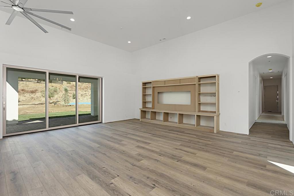 5808 Lake Vista Drive Bonsall, CA 92003 - Photo 7 of 40 a view of an empty room with wooden floor and a window