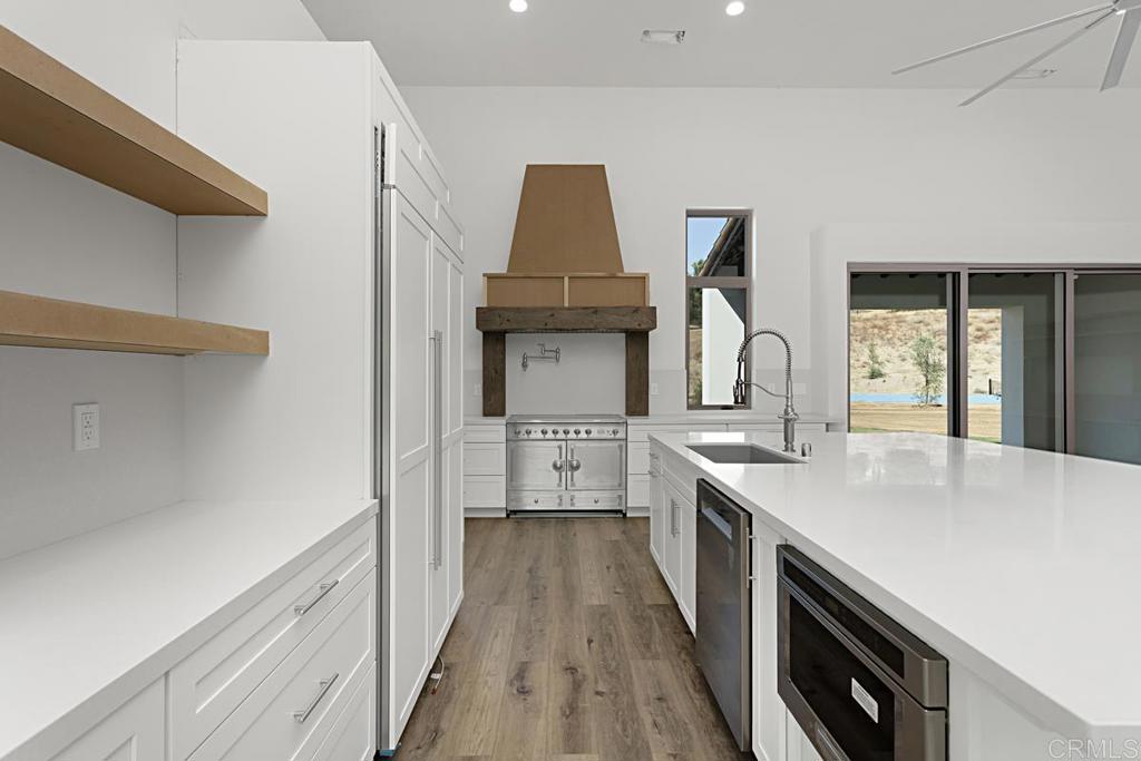 5808 Lake Vista Drive Bonsall, CA 92003 - Photo 10 of 40 a kitchen with a sink and wooden floor