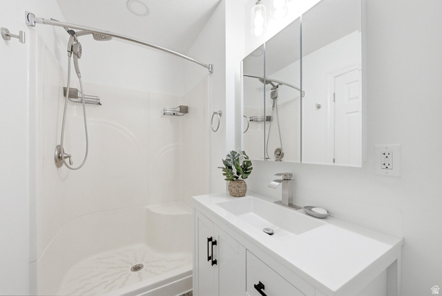 120 North 1230 E Street Springville, UT 84663 - Photo 15 of 60 Bathroom vanity with a rectangular undermount sink, brushed nickel faucet, and a wall-mounted medicine cabinet