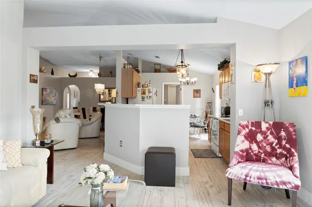 a kitchen with stainless steel appliances kitchen island granite countertop a refrigerator and a stove top oven