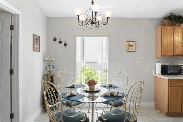 a view of a dining room with furniture and chandelier