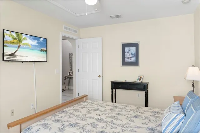 a view of a hallway with furniture and a potted plant