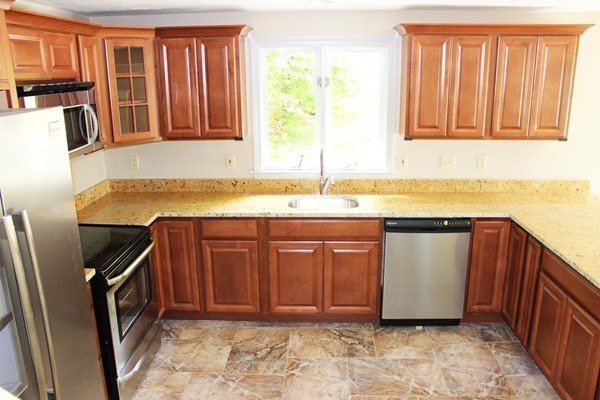 24 Sycamore Drive Rutland, MA 01543 - Photo 12 of 30 a view of a kitchen with stainless steel appliances granite countertop a refrigerator and a sink