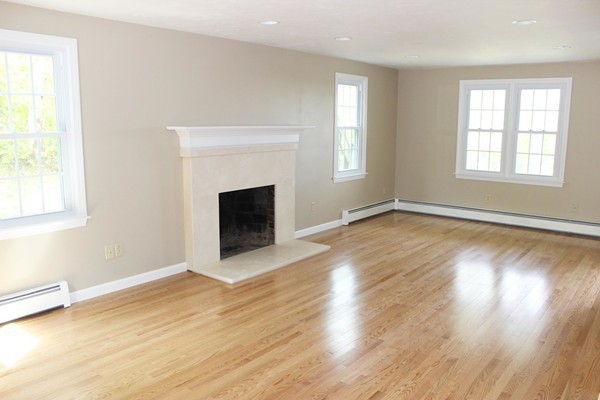 24 Sycamore Drive Rutland, MA 01543 - Photo 8 of 30 an empty room with wooden floor fireplace and windows
