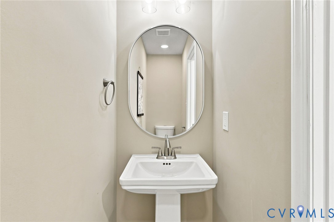 3221 Clintwood Road Midlothian, VA 23112 - Photo 18 of 46 Pedestal sink with a brushed nickel faucet, an ova