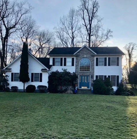 a front view of house with yard and green space