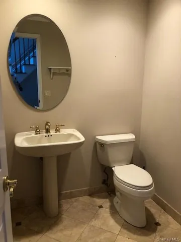 a kitchen with kitchen island granite countertop white cabinets and stainless steel appliances