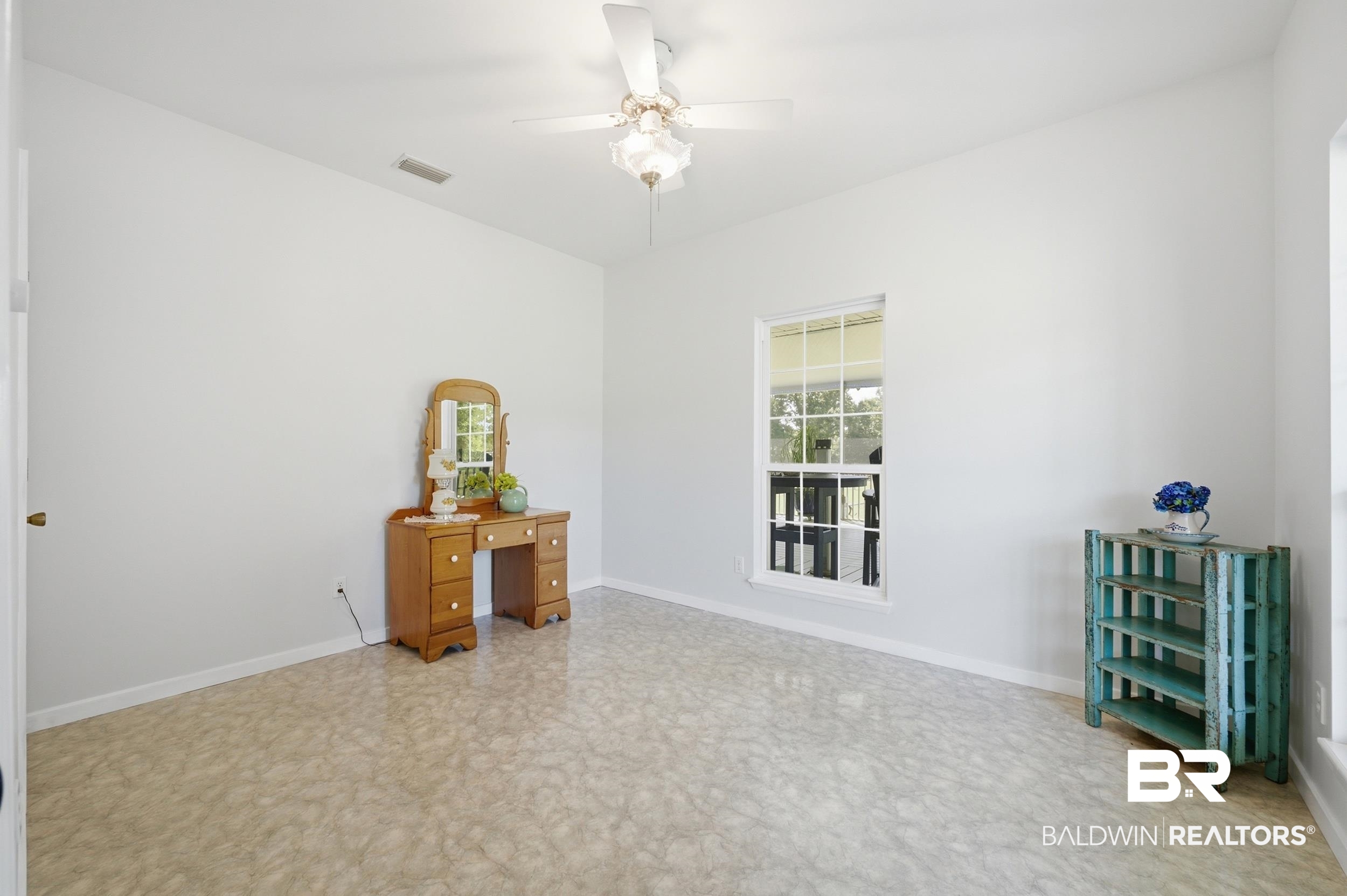 15855 Calvin Richerson Road Bay Minette, AL 36507 - Photo 42 of 83 Spacious room featuring light-colored flooring, neutral wall tones, a single window with white framing, and a ceiling fan with light fixture