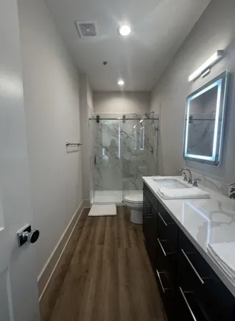 a bathroom with a double vanity sink and mirror