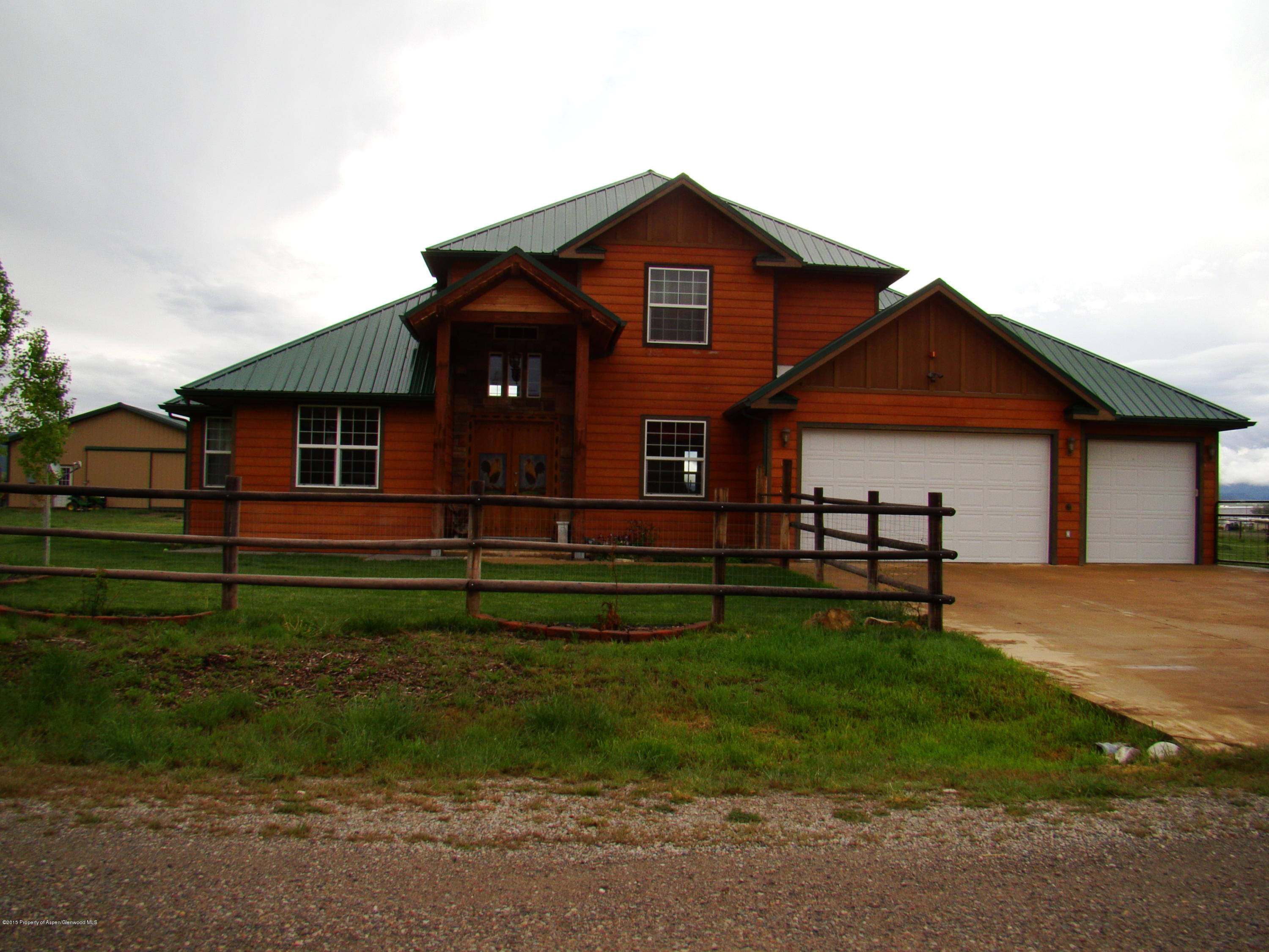 136 Native Springs Drive Rifle, CO 81650 - Photo 1 of 42 a front view of a house with a yard
