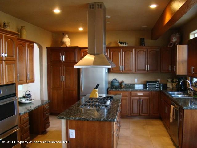 136 Native Springs Drive Rifle, CO 81650 - Photo 31 of 42 a kitchen with stainless steel appliances granite countertop a sink stove and refrigerator