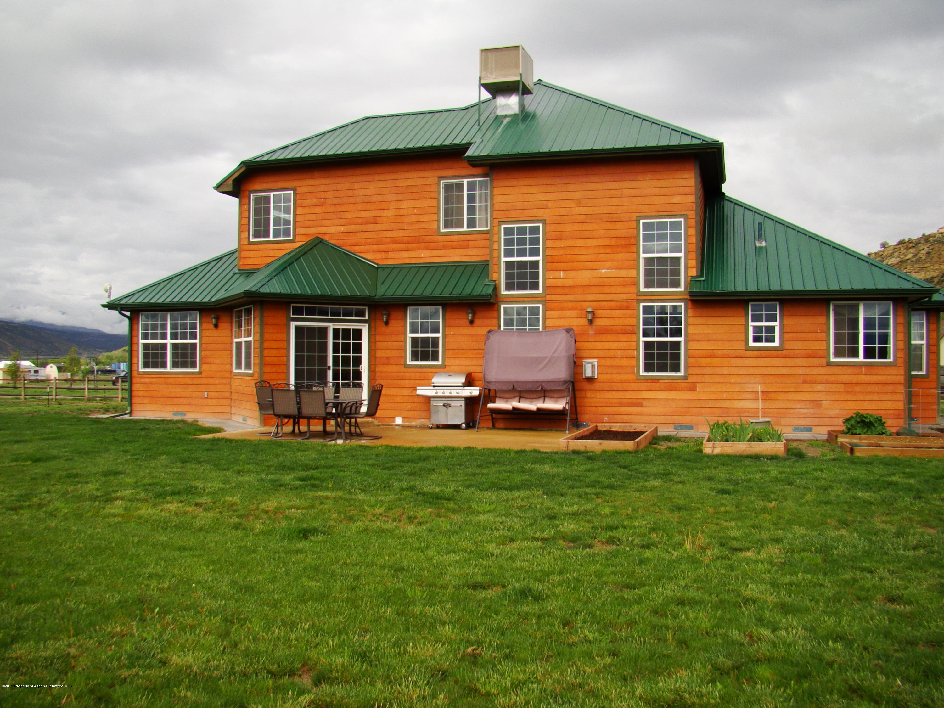 136 Native Springs Drive Rifle, CO 81650 - Photo 10 of 42 a front view of a house with a yard
