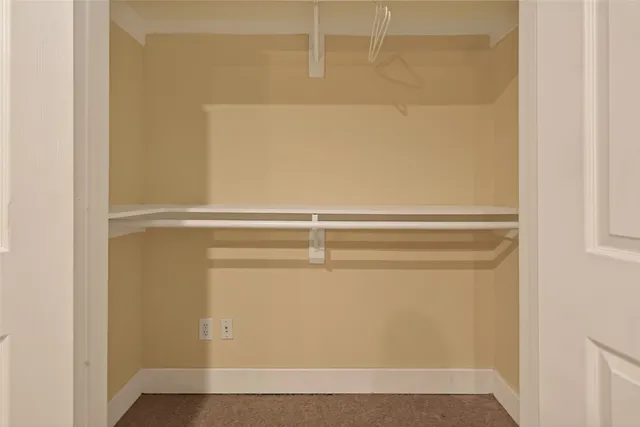a view of a storage and utility room with washer and dryer