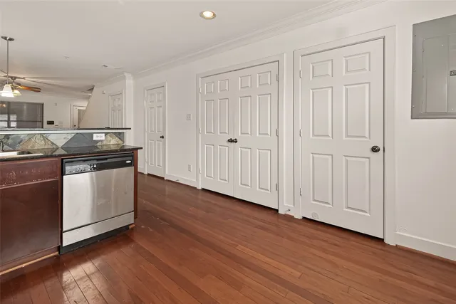 a view of an empty room with window and wooden floor