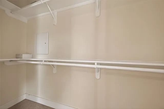 an empty room with chandelier fan