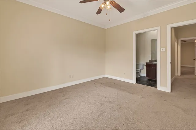 an empty room with chandelier fan