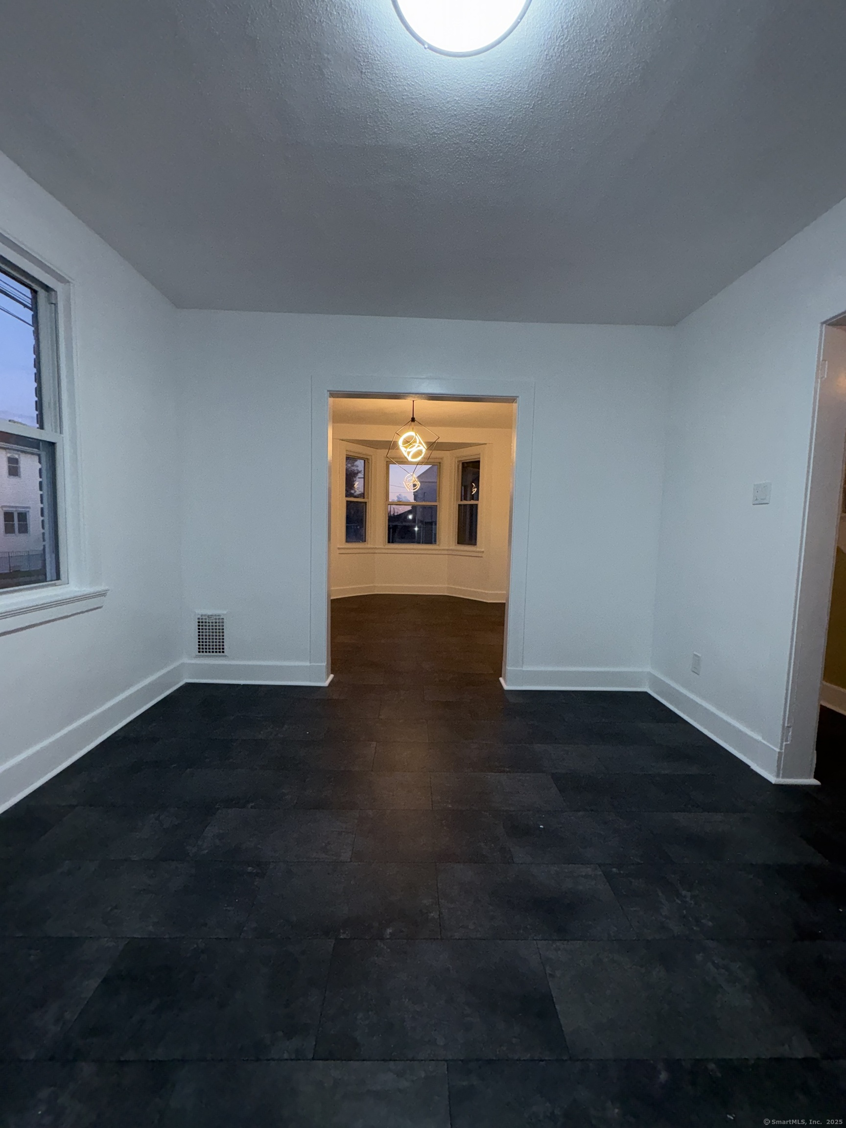 1922 Boston Avenue Bridgeport, CT 06610 - Photo 14 of 31 an empty room with wooden floor and windows