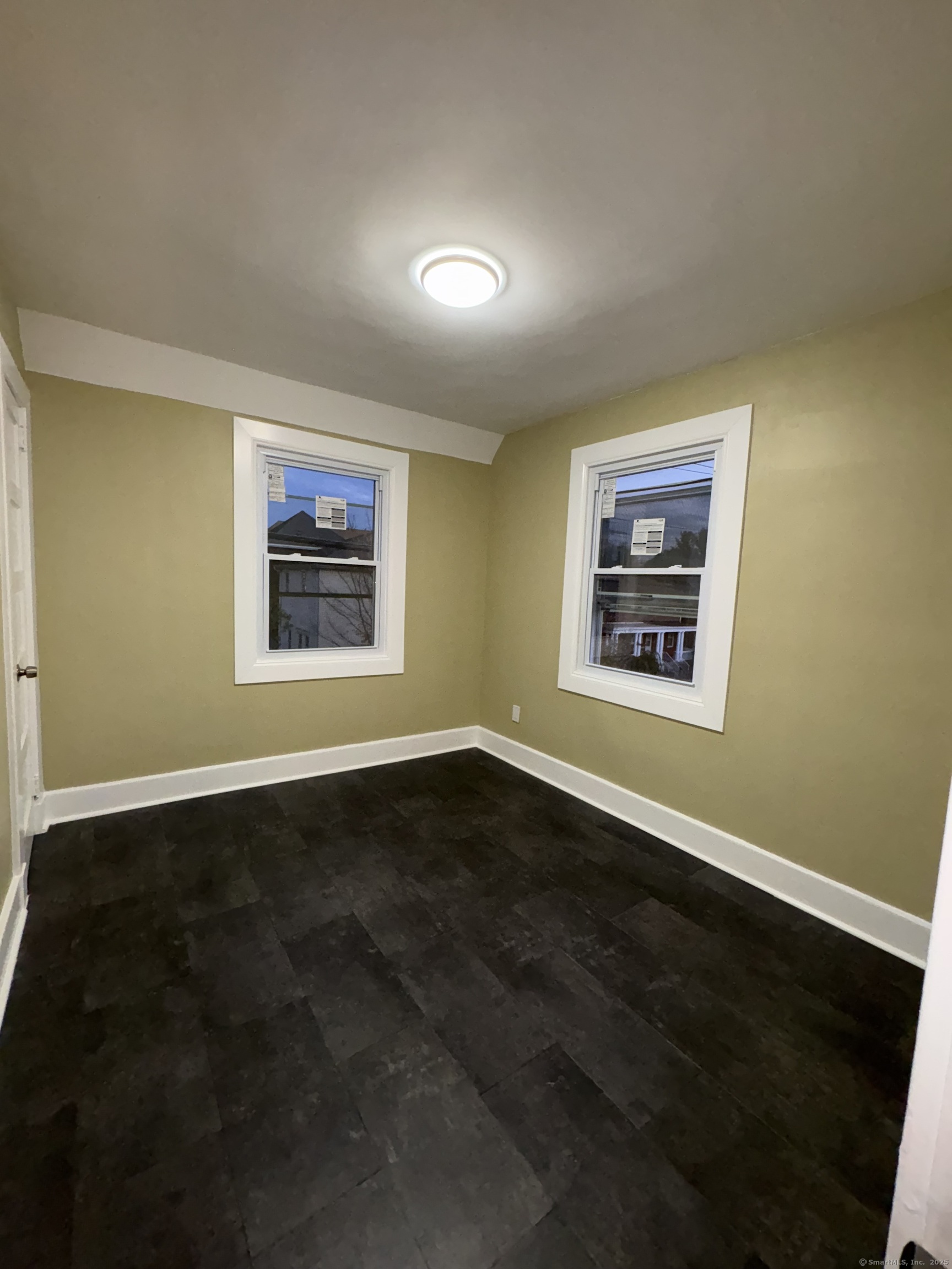 1922 Boston Avenue Bridgeport, CT 06610 - Photo 18 of 31 an empty room with wooden floor and windows