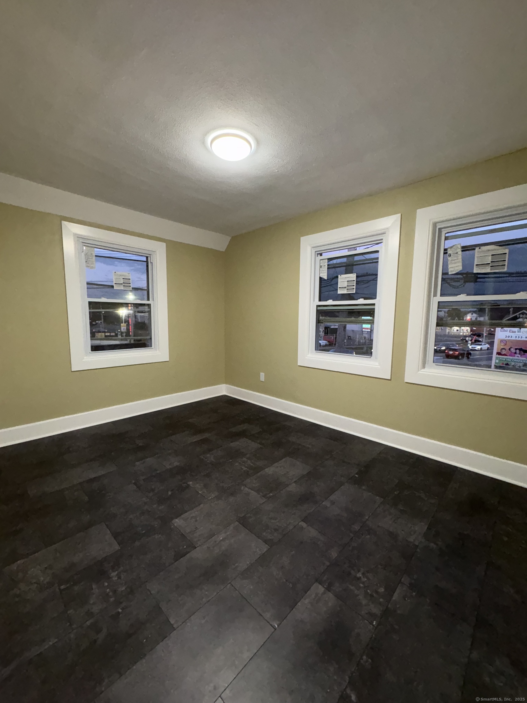 1922 Boston Avenue Bridgeport, CT 06610 - Photo 19 of 31 a view of an empty room with window and wooden floor