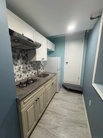 a kitchen with stainless steel appliances a stove and a refrigerator