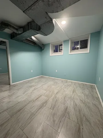 a view of a room that has a bed and a window