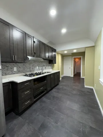 a spacious bathroom with a granite countertop sink and a large mirror